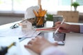 Architect using digital tablet and working with construction plans at office desk. Royalty Free Stock Photo