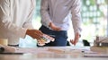 Cropped shot of Architecture team meeting/deciding to color on work desk. Royalty Free Stock Photo