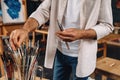 Cropped shot of artist choosing perfect paintbrush