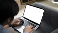 Asian man using laptop computer laptop and lying on sofa. Royalty Free Stock Photo