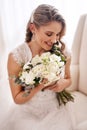 Lets get this show on the road. Cropped shot of an attractive young bride sitting alone in the dressing room and holding Royalty Free Stock Photo