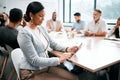 The meeting is underway. Cropped shot of an attractive young businesswoman attending a meeting in the boardroom with her Royalty Free Stock Photo