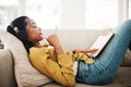 Music helps me focus. Cropped shot of an attractive young businesswoman lying down on her couch and listening to music Royalty Free Stock Photo