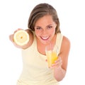 Shes getting her Vitamin C alright. Cropped shot of an attractive young woman drinking orange juice while holding half a Royalty Free Stock Photo