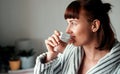 Hydration is a priority to her. Cropped shot of an attractive young woman drinking water in her bedroom at home. Royalty Free Stock Photo