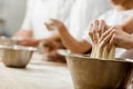 cropped shot of baking manufacture workers kneading