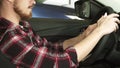 Cropped shot of a bearded man sitting in a car holding the steering wheel