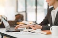 Cropped shot of a beautiful Asian businesswoman using a digital laptop at her desk in a modern office. Royalty Free Stock Photo