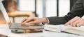 Cropped shot of a beautiful Asian businesswoman using a digital laptop at her desk in a modern office. Royalty Free Stock Photo