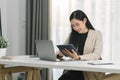Cropped shot of a beautiful Asian businesswoman using a digital laptop at her desk in a modern office. Royalty Free Stock Photo