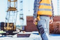 Cropped shot of builder in reflective vest standing