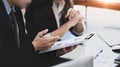 Cropped shot of business people in blank suit analizing financial documents.