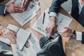 cropped shot of business people having conversation with contracts and speakerphone on table Royalty Free Stock Photo