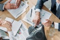 cropped shot of business people having conversation with contracts and speakerphone on table Royalty Free Stock Photo