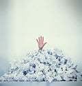 Help Im drowning in paperwork. Cropped shot of a businessman buried under a pile of crumpled up paperwork.