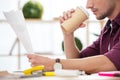 cropped shot of businessman with coffee to go doing paperwork at workplace Royalty Free Stock Photo