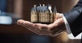 cropped shot of businessman holding model of fairytale castle in hands