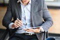 Businessman sitting on comfortable chair and using smart phone. Royalty Free Stock Photo