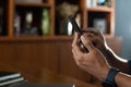 Cropped shot of businessman using mobile phone while sitting in modern office. Royalty Free Stock Photo