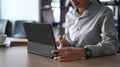 Businesswoman searching information on computer tablet at office desk. Royalty Free Stock Photo