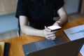 Businesswoman using smart phone searching information and working with laptop compute on wooden table. Royalty Free Stock Photo