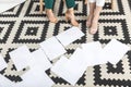 cropped shot of businesswomen sitting near blank papers on floor