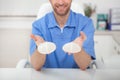 Plastic surgeon showing breast implants to a patient Royalty Free Stock Photo