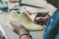 cropped shot of cobbler holding pencil and working with unfinished footwear Royalty Free Stock Photo