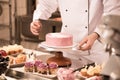 cropped shot of confectioner making cake Royalty Free Stock Photo