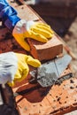 Cropped shot of construction worker in protective gloves laying bricks Royalty Free Stock Photo