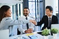 Partnering up to achieve success. Cropped shot of corporate businesspeople shaking hands in the workplace.