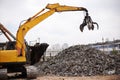 Mean industrial machine. Cropped shot of a crane at work in a dumpsite. Royalty Free Stock Photo