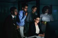 Gather round everyone. Cropped shot of a diverse group of businesspeople gathered around a single computer in their