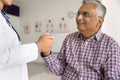 Cropped shot of doctor holding hand of senior Indian patient Royalty Free Stock Photo