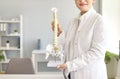 Cropped shot of doctor at orthopedic clinic holding anatomical model of human spine