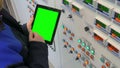 Cropped shot of engineer with digital tablet standing near control panel Royalty Free Stock Photo