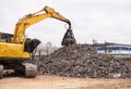 Just another day in the scrapyard. Cropped shot of an excavator sorting through a pile of scrap metal. Royalty Free Stock Photo