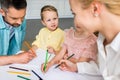 cropped shot of family with two kids drawing with colored pencils Royalty Free Stock Photo