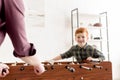 cropped shot of father and cute smiling son playing table football together Royalty Free Stock Photo