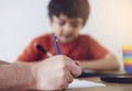 Cropped shot father helping his boy with homework, Dad and Son doing homework together, Selective focus Teacher teaching little Royalty Free Stock Photo