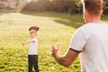 cropped shot of father and son playing with rugby ball