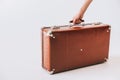 cropped shot of female hand holding retro suitcase Royalty Free Stock Photo