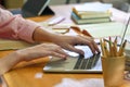 Cropped shot female hands using laptop computer on library table Royalty Free Stock Photo