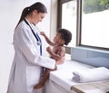 Just in for a routine pediatric checkup. Cropped shot of a female pediatrician doing a checkup on an adorable baby boy. Royalty Free Stock Photo