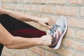 Cropped shot of female in sportswear and sneakers ready for training or running.