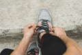 Cropped shot of female in sportswear and sneakers ready for training or running.