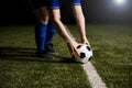 Soccer player placing the football on center line