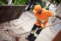 Ridding the streets of rubbish. Cropped shot of a garbage collection worker sweeping the sidewalk.