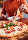 Cropped shot of Girl taking slice of pepperoni pizza Royalty Free Stock Photo