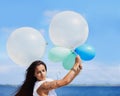 Sometimes you have to hold on tightly. Cropped shot of a gorgeous tattooed young woman holding balloons. Royalty Free Stock Photo
